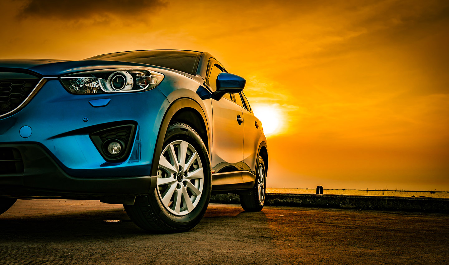 Blue compact SUV car with sport and modern design parked on conc